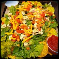 Tortilla Chicken Salad · A bed of scatterred tortilla chips topped with romaine lettuce, marinated diced chicken brea...