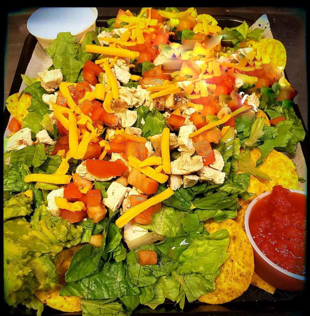 Tortilla Chicken Salad · A bed of scatterred tortilla chips topped with romaine lettuce, marinated diced chicken breast, avocado, tomatoes and shredded cheddar cheese. Served with sides of salsa and sour cream.