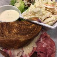 Reuben · Thinly sliced corned beef topped with a blend of sauerkraut and 1000 Island dressing and cov...