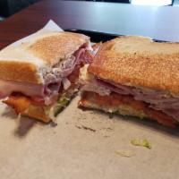 The Club · This classic sandwich combines thinly sliced ham and white turkey breast, melted swiss chees...