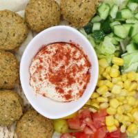 Falafel Plate · 6-8 falafels on a pita bread, next to our chopped salad with a side of hummus & extra tahini...