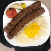 Ground Beef Kabob ( Koobideh ) · 2 skewers of charbroiled ground beef sitting on top of white basmati rice topped with saffro...