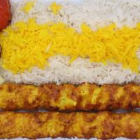 Ground Chicken Kabob ( Koobideh ) · 2 skewers of charbroiled ground chicken breast  sitting on top of white basmati rice topped ...