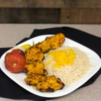 Boneless Chicken Breast Kabob · Skewer of charbroiled chicken breast tender sitting on top of white basmati rice topped with...
