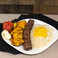 Combo ( Beef & Chicken ) · Skewers of charbroiled chicken breast tender & a ground beef kabob sitting on top of white b...