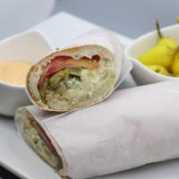 Olovieh Sandwich (Chicken Salad) · Our chicken potato salad with tomatoes, pickles, our house sauce and chopped parsley in a to...