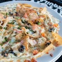 Italian Nachos · Deep fried tortilla chips topped with chicken, onions, tomatoes, Asiago sauce and mozzarella...