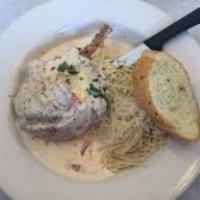 Blackened Stuffed Pork Chop · Hand stuffed with aged pepper jack cheese and fresh crab meat, smothered in Asiago sauce mix...