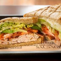 Turkey Club · Smoked turkey, Swiss cheese, grilled bacon, lettuce, tomato, mayo, and avocado on white bread.