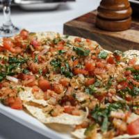 Masala Papad · Traditional Indian lentil chips seasoned with chef's spices and garnished with onion, tomato...