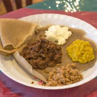 6. Keyi Begg Wott · Tender lamb stew slowly simmered in Berbere sauce, garlic and authentic Ethiopian spices. Se...
