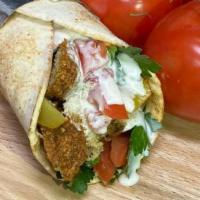 Falafel Sandwich · 2 pieces of falafel, fresh chopped parsley, tomatoes, pickles and tahini sauce. Vegetarian.