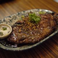Mekhong Pork Chop · Thai dark rum marinated pork chop sirloins with ginger, cherry wine, and herbs, served with ...