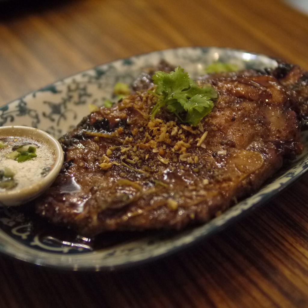 Mekhong Pork Chop · Thai dark rum marinated pork chop sirloins with ginger, cherry wine, and herbs, served with sauteed mixed vegetables in garlic sauce.