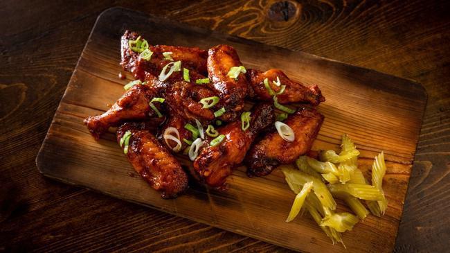 BBQ Wings · Slow-smoked for 2 hours before being flash-fried and tossed in our house-made BBQ Sauce. Topped with scallion. Served with celery.