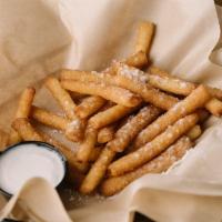 Funnel Cake Fries · Funnel cake fries tossed in cinnamon sugar and served with homemade frosting.