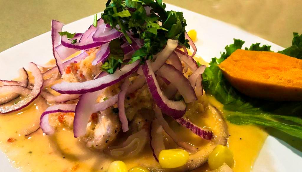 Ceviche de Pescado · Pieces of fish (seabass or mahi-mahi) marinated with fresh lime juice red onions topping side of Peruvian soft corn and sweet potatoes.