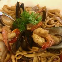 Tallarin con Mariscos · Fettuccine or linguine sauteed with calamari, scallops, mussels, shells and crab nails in ou...