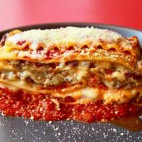 Beef Lasagna · Served with garlic rolls.