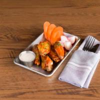 Wings Confit · Tossed in Sriracha BBQ sauce or Buffalo Sauce, served with ranch or blue cheese sauce.