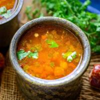 Rasam · Tangy spicy tomato soup with tamarind and spices.