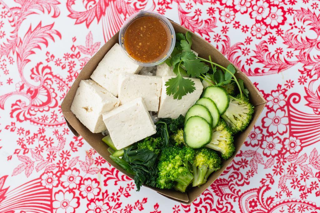 Veggie Khao Man Gai · Tofu-based Khao Man Gai with no animal products used anywhere. Steamed OTA tofu and steamed broccoli served on brown Jasmine rice with Nong’s sauce. Vegetarian and Vegan-friendly.