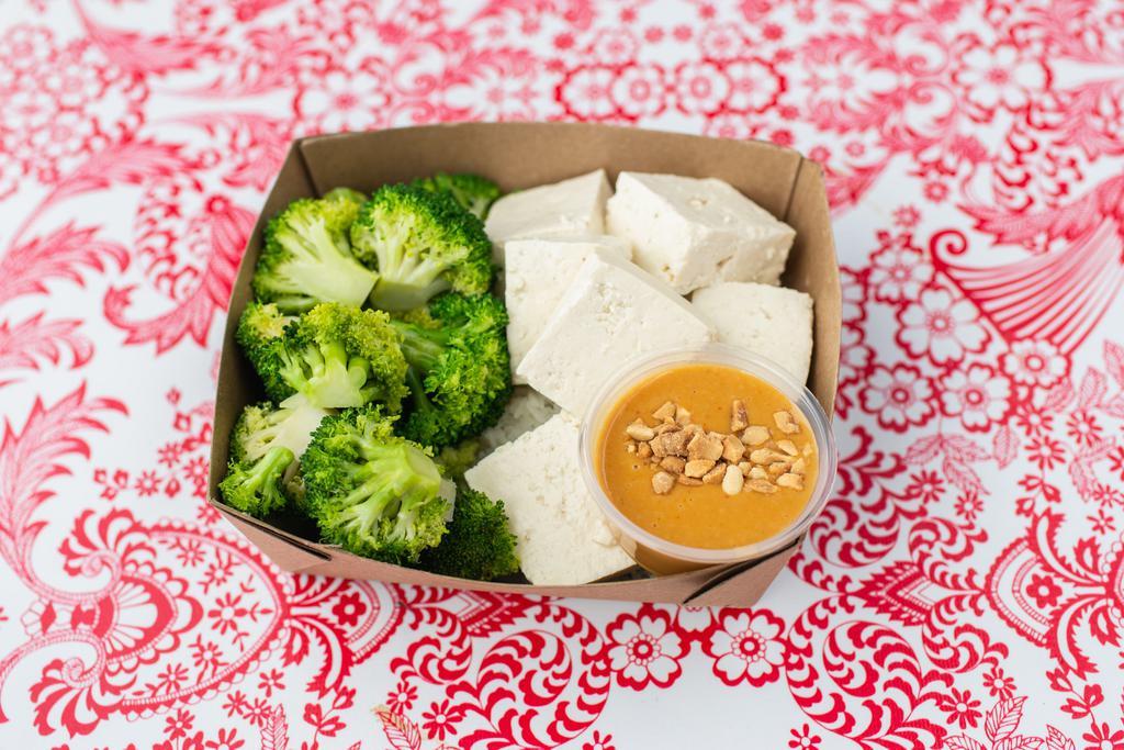Tofu Peanut (V/GF) · Steamed OTA tofu and steamed broccoli served on brown Jasmine rice with Nong’s peanut sauce (GF). Vegetarian and Vegan-friendly.
