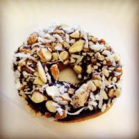 Almond Joy Donut · Chocolate icing, topped with sweetened coconut and chopped almonds.