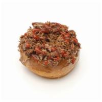 The Beast Donut · Cinnamon and sugar on the bottom, maple icing topped with bacon pieces and a hot sauce drizz...