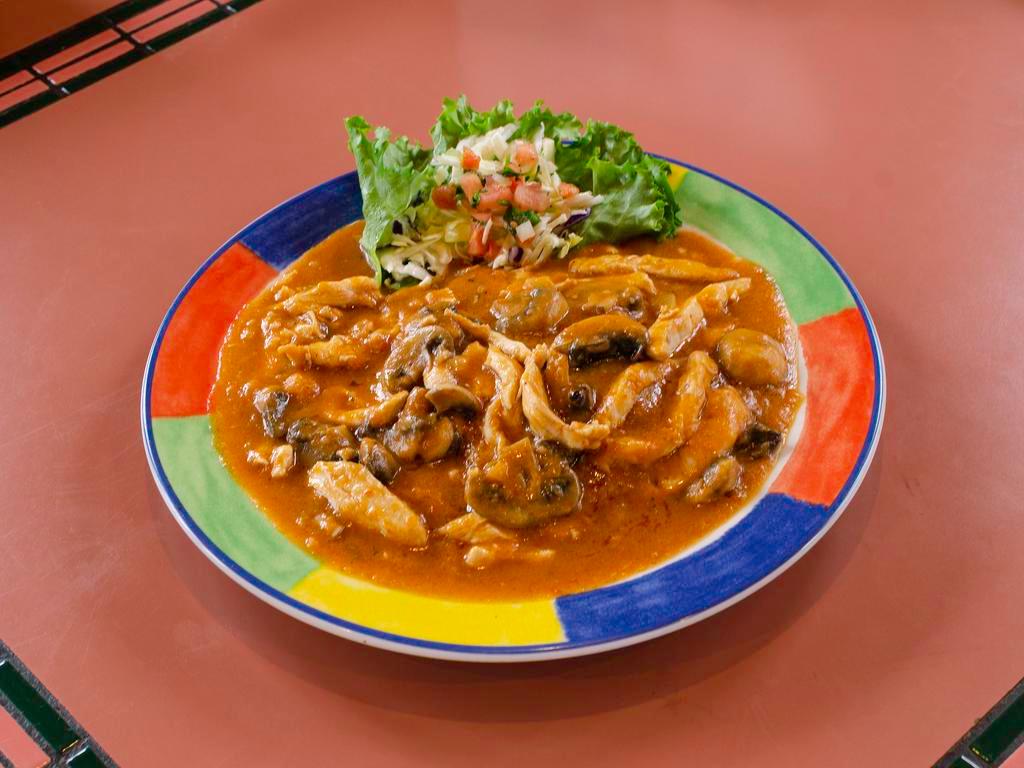 Arroz con Pollo · Boneless breast of chicken sauteed in a light tomato sauce with mushrooms and onions, served over a bed of rice with melted Jack cheese.