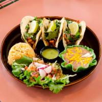 Tacos Autenticos · 3 tacos made with corn tortillas, filled with char-broiled steak or chicken, finished with w...