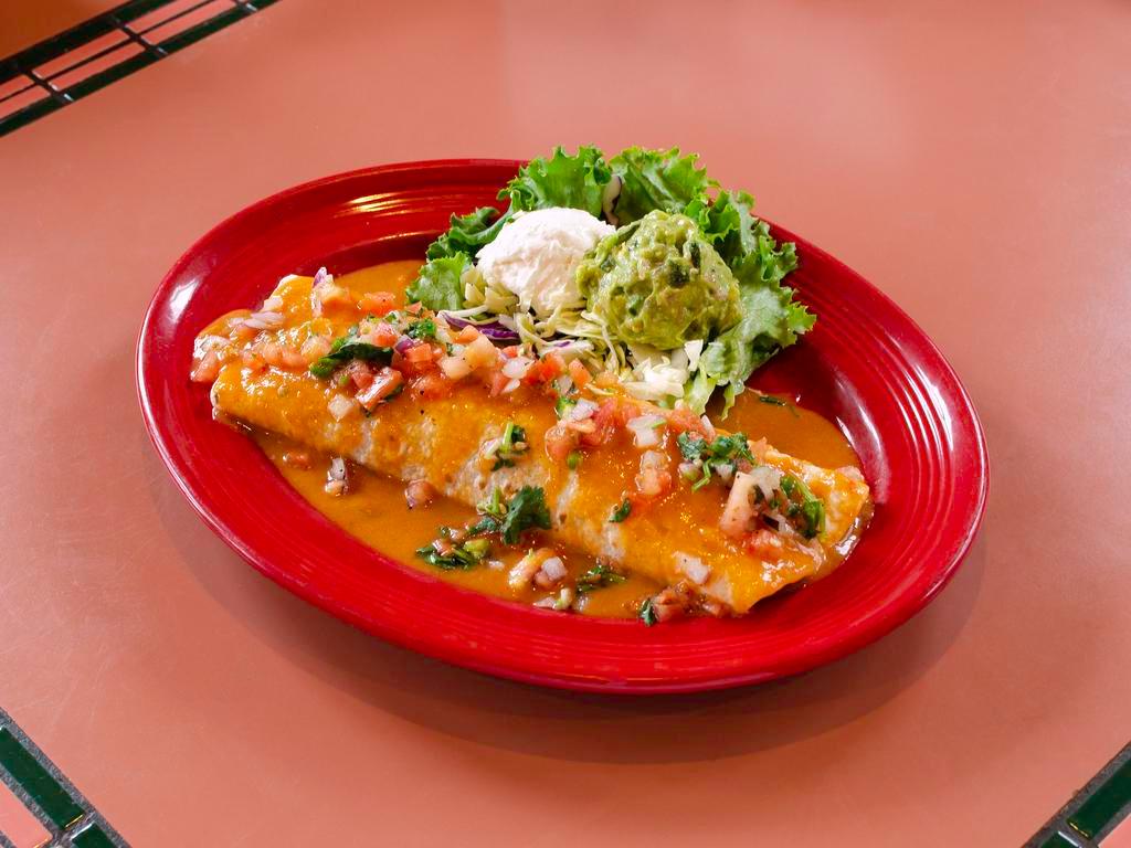 Fajita Burrito · Flour tortilla stuffed with choice of meat, rice, beans, grilled onions and green peppers topped with arroz con pollo sauce and garnished with pico de gallo, sour cream and guacamole.
