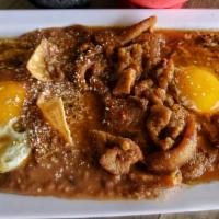 Rancheros Puercos · 2 eggs over fried tortillas with pork skin in sauce, beans, and 2 salsas.  Add beverage for ...