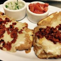 Molletes c/ chorizo · 2 halves of bread covered with fried beans and melted cheese, pico de gallo, and chorizo on ...