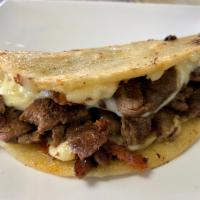 Quesadilla · Corn tortilla and melted chesse with ingredient to choice inside.