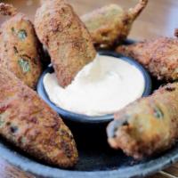 Stuffed Jalapenos Spicy 6 Pieces · Jalapenos stuffed with pork, Monterey and chipotle cream for dipping. Spicy.