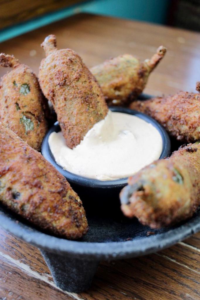 Stuffed Jalapenos “Spicy” (6 pcs) · Jalapenos stuffed pork, Monterey, and chipotle cream for dipping.