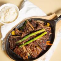 Kalbee · Grilled marinated beef short rib set on top of sauteed vegetalbe served with steamed rice.