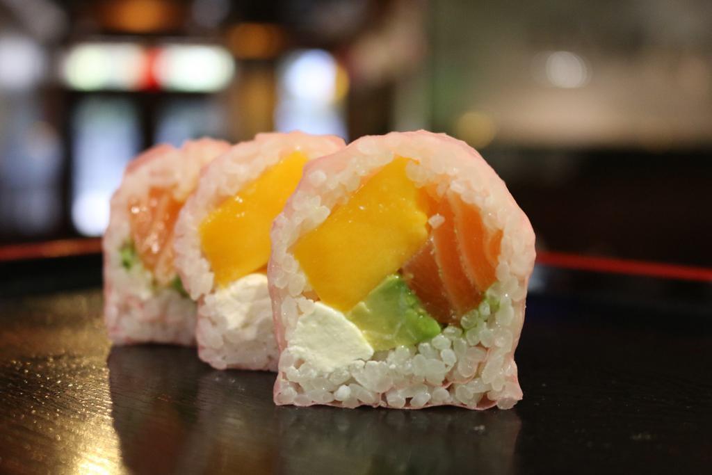 Mango Fandango Roll · Salmon, mango, avocado, with cream cheese wrapped in soy paper with wasabi sauce.