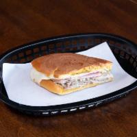 Medianoche Sandwich · Roasted pork, ham, cheese, pickles, mustard, and mayo served on a sweet egg bread.