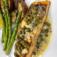 Salmone Piccata · Grilled filet of salmon topped with a lemon-caper butter sauce served with roasted Yukon Gol...