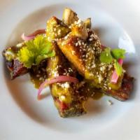 Costilla Verde · (3) fried st.louis pork ribs, sauteed in salsa verde, topped with queso blanco, pickled red ...