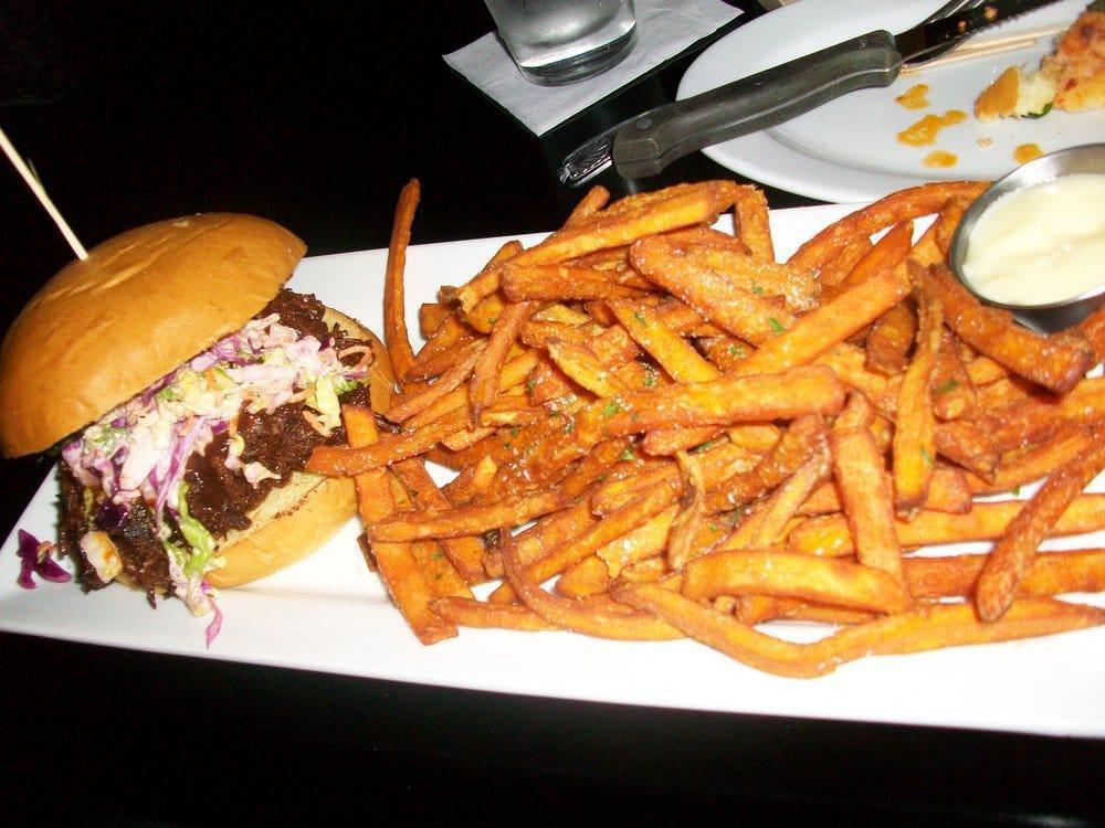 BBQ Pulled Pork · Braised pulled pork, house made BBQ sauce, spicy coleslaw, house-made bun, served with hand-cut fries.