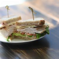 New England Turkey Sandwich · Roast native turkey, lettuce,  tomatoes, cheddar, cranberry mayo.