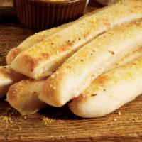 Breadsticks · Fresh-baked bread strips with garlic sauce and Italian spices, served with a side of our ori...