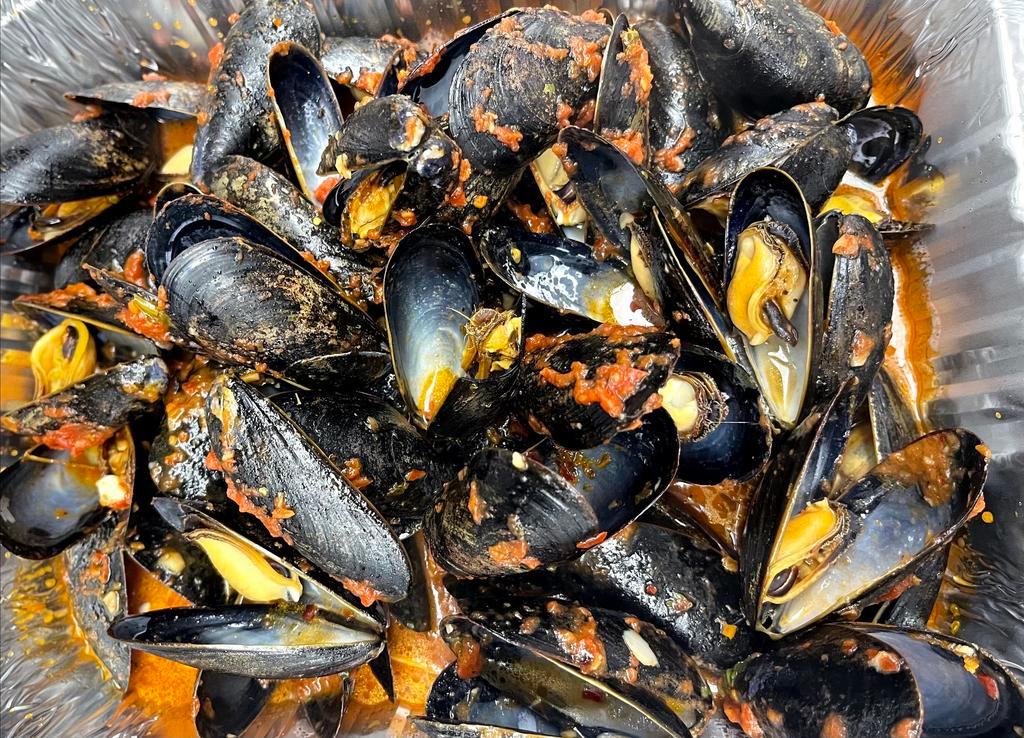Mussels in Red or Garlic Sauce · Mussels cooked in a red or garlic sauce.