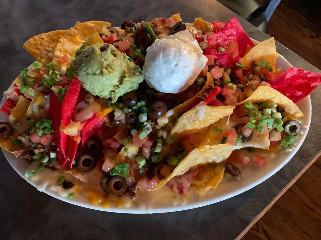 Deluxe Nachos · Ground beef, black olives, jalapenos, onions, tomatoes, sour cream and guacamole. Accompanied with salsa.