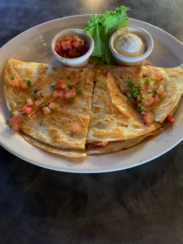 Fajita Quesadilla · A grilled flour tortilla stuffed with cheese, grilled chicken, sautéed peppers and onions. Served with sour cream and salsa.