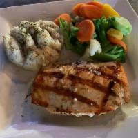 Fresh Northwest Salmon · Flame broiled Northwest salmon, brushed with lemon dill butter. Served with garlic mashed po...