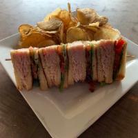 Turkey Club Sandwich · A triple decker filled with roasted turkey, bacon, crisp lettuce, and tomatoes. Served on to...